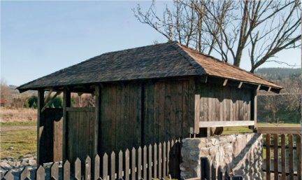 Woodshed roofed with hardened pine